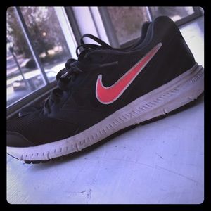 Black and Pink nike tennis shoes.